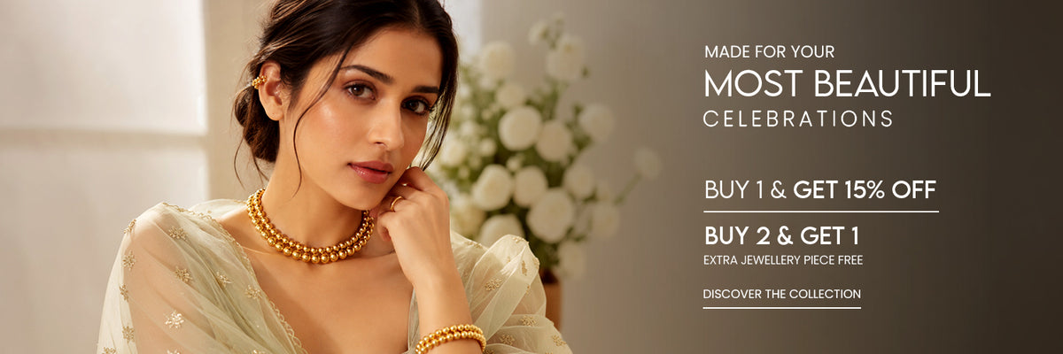 A woman in a light green traditional outfit wearing gold beaded jewelry, including a necklace and bracelet, posed against a soft blurred background with promotional text on the right. | This festive, glam with Armúr
